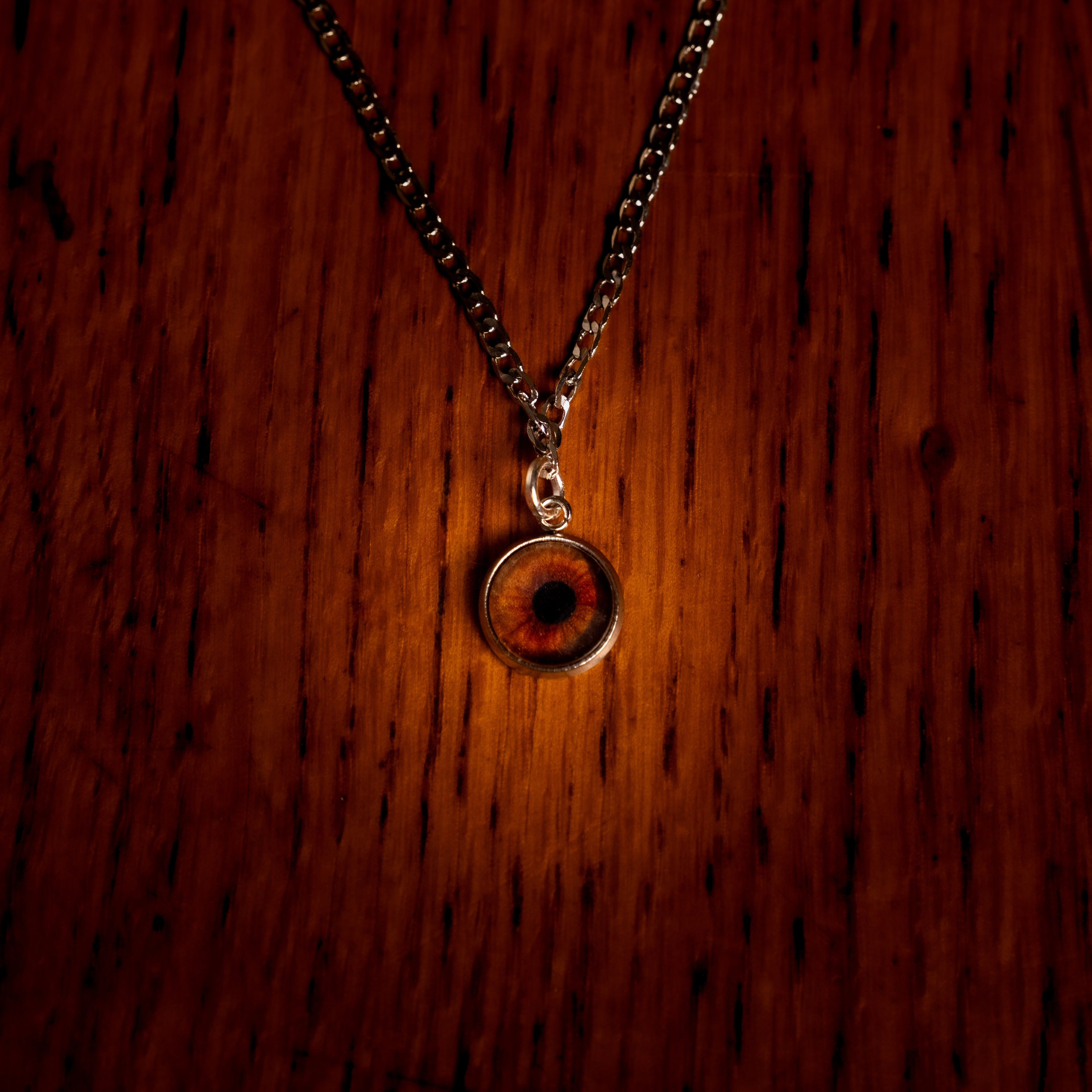 Necklace with a round pendant on a wooden surface
